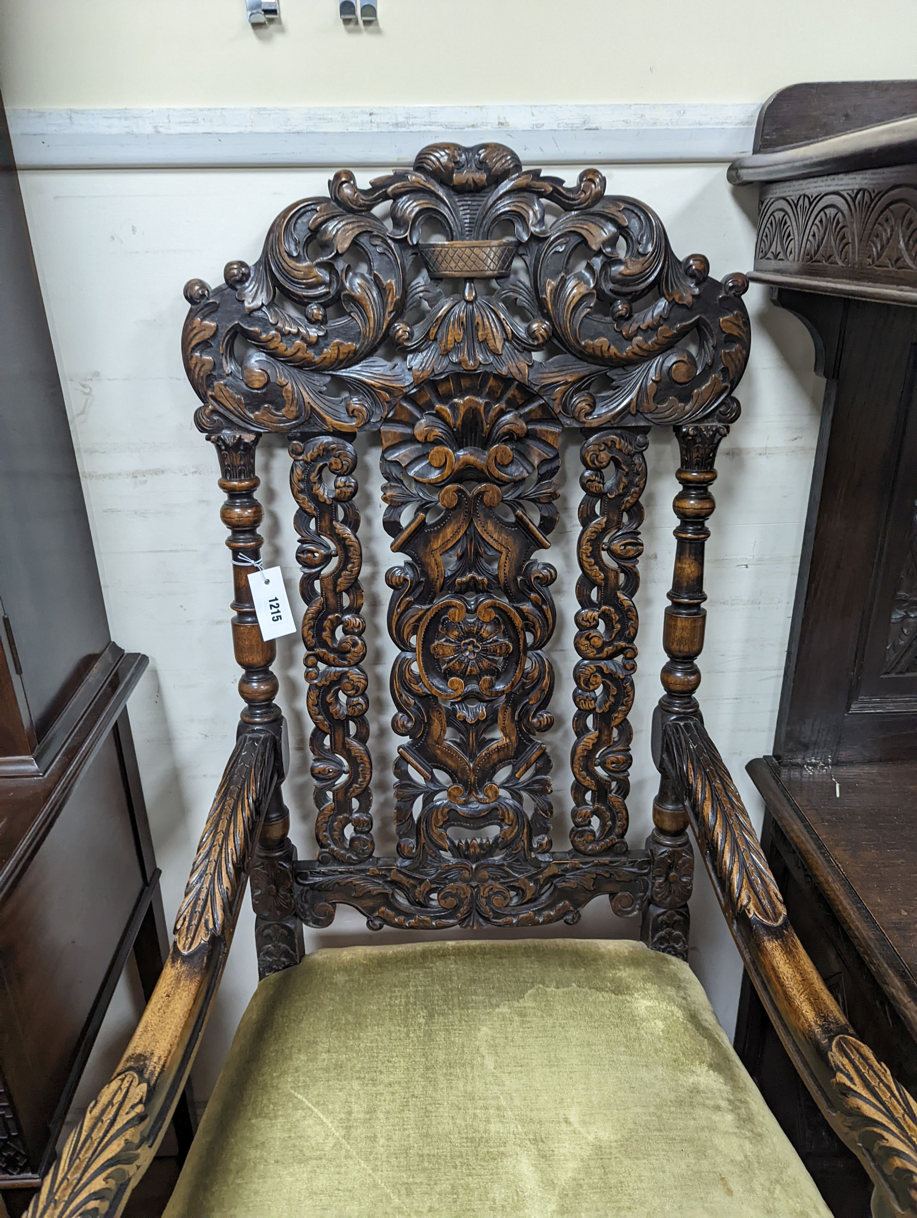 A pair Charles II style carved oak elbow chairs with upholstered seats on turned underframes, width 63cm, depth 54cm, height 133cm